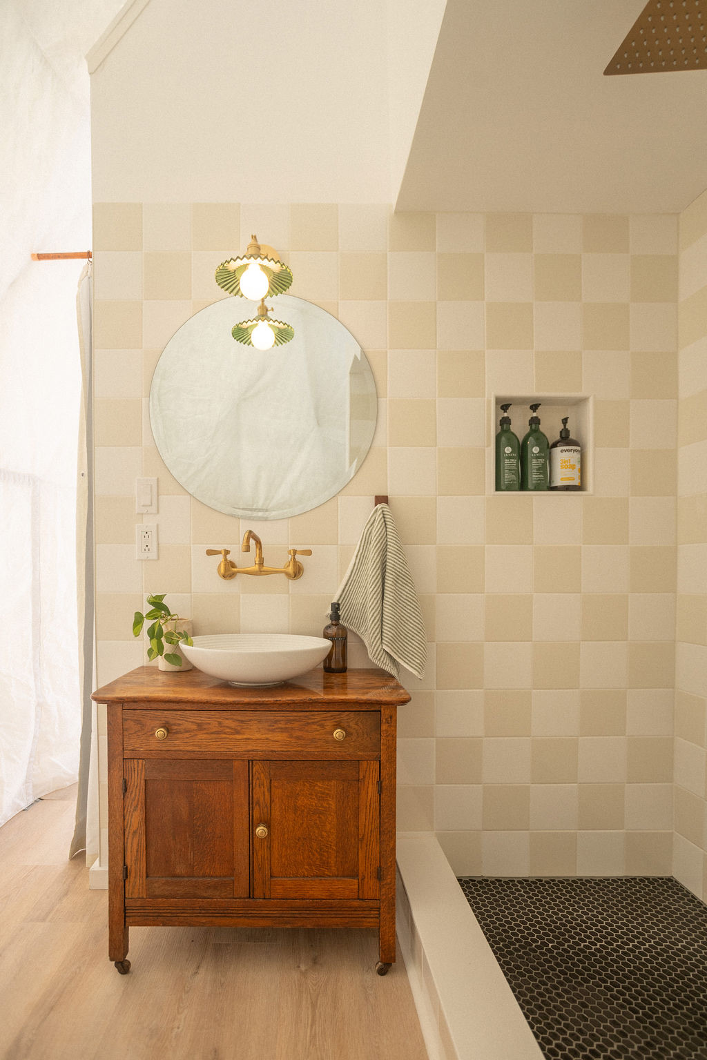 Bathroom with antique wood vanity, vessel sink, round mirror, and tiled walk-in shower at Short Mountain Holiday