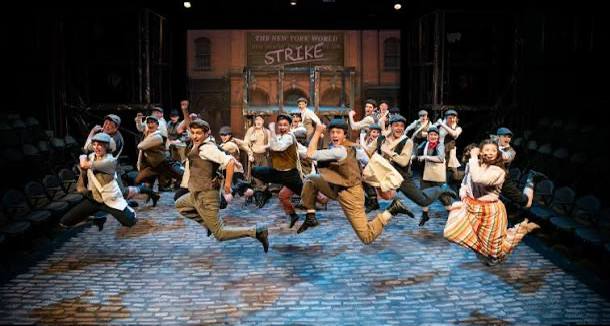 Cast mid-leap during a musical performance on stage at the Arts Center of Cannon County in Woodbury, Tennessee